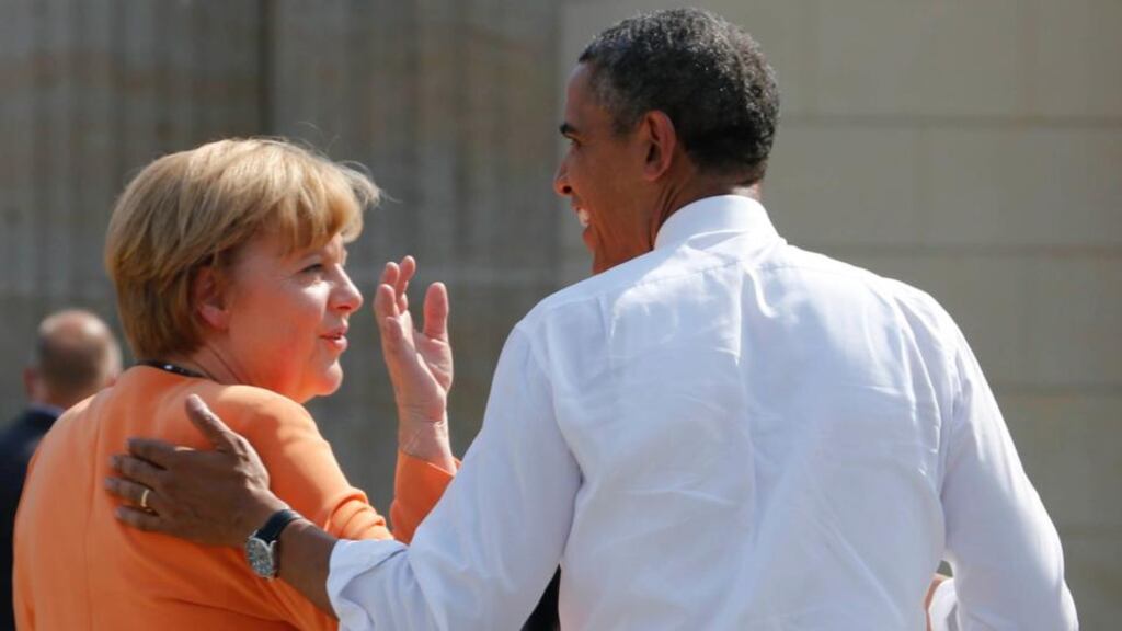 File photo of US President Barack Obama chating with German Chancellor Angela Merkel  at the Brandenburg Gate in Berlin in June. Mr  Obama knew since 2010 his intelligence service was eavesdropping on German leader Angela Merkel and even asked for more data on her, according to a newspaper reported today, a day after reports alleged he told her he had had no idea. Photograph: Wolfgang Rattay/Reuters