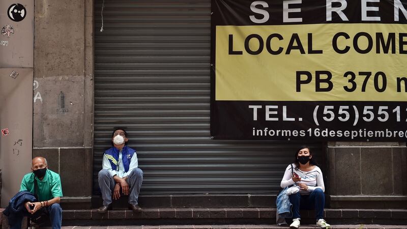 People wear face masks outside a closed shop for rent in Mexico City. Photograph: Rodrigo Arangua/Getty/AFP