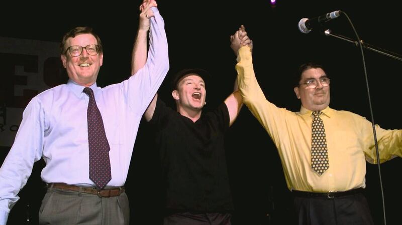 U2 lead singer Bono holds up the arms of Ulster Unionist leader David Trimble and SDLP leader John Hume on stage during the May 1998 concert at the Waterfront Hall in Belfast. Photograph: Gerry Penny/AFP/Getty Images