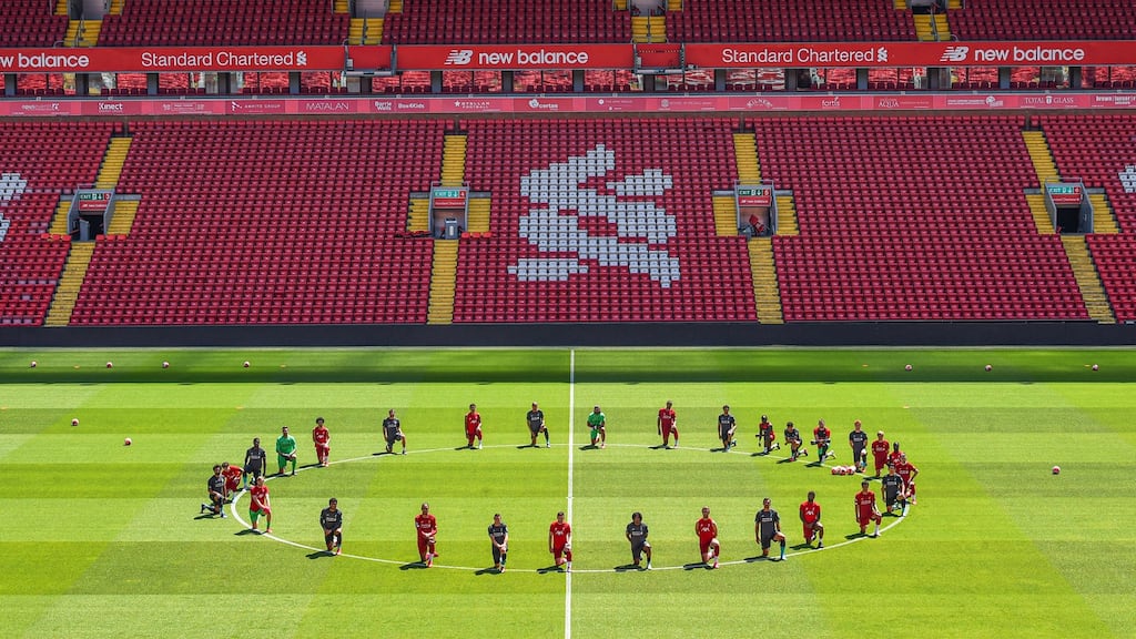 Liverpool players take a knee in memory of George Floyd at Anfield on Monday. Photo: Andrew Powell/Liverpool FC via Getty Images
