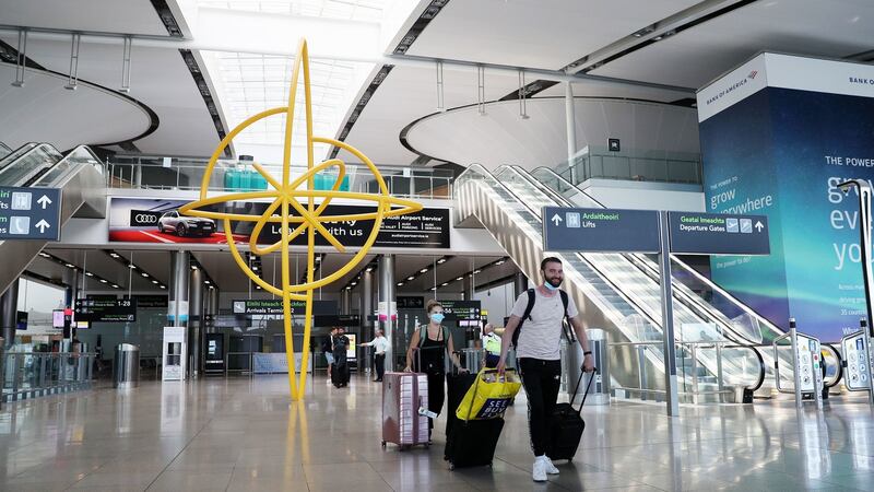 People in face masks in Terminal 2 of Dublin Airport. Those arriving must alert the authorities as to where they will be self-isolating. Photograph: Brian Lawless/PA