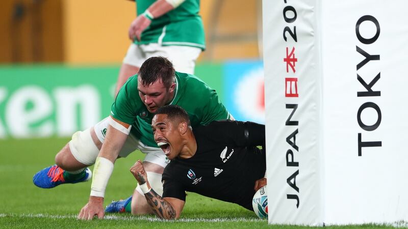 Aaron Smith celebrates his first try as Peter O’ Mahony dives in. Photo: Stu Forster/Getty Images