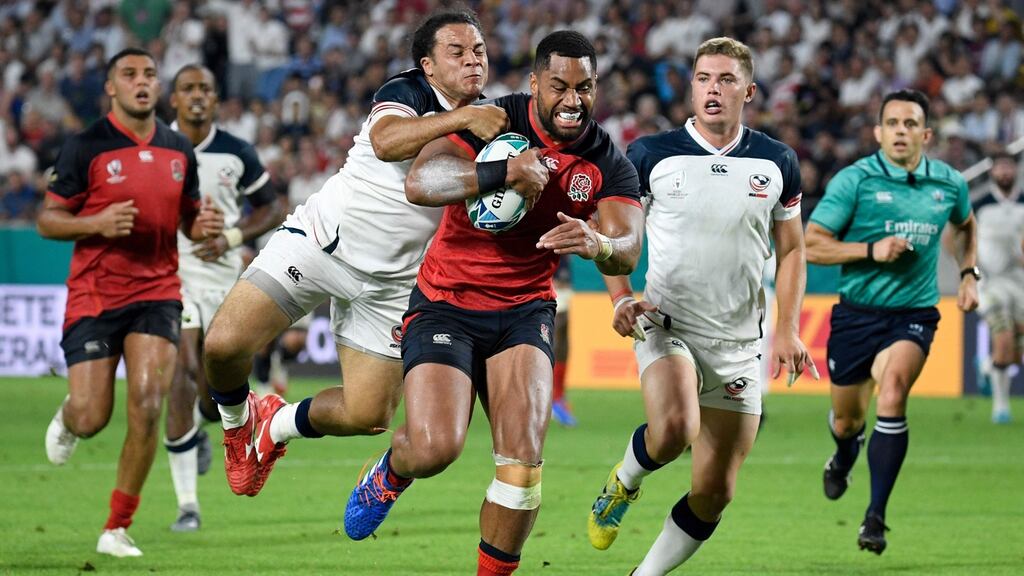 England winger Joe Cokanasiga is tackled by USA prop David Ainuu as he runs in to score a try during Rugby World Cup Pool C at the Kobe Misaki Stadium. Photograph: Filippo Monteforte/AFP/Getty Images