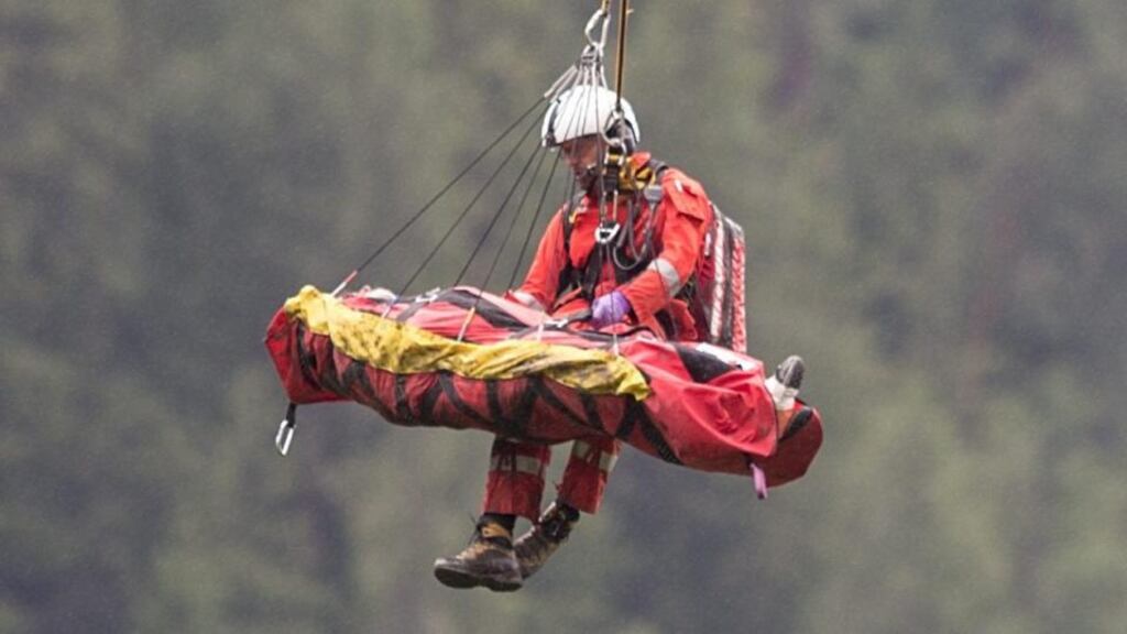 Rescue services airlift a victim of the passenger train crash near Tiefencastel, Switzerland today. A passenger train travelling from St Moritz to Chur in eastern Switzerland has been derailed by a landslide, local police said. Photograph: EPA