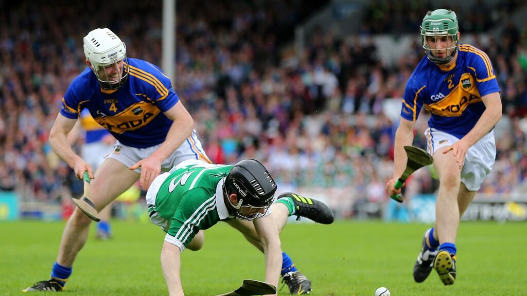 Tipperary’s Michael Cahill and Cathal Barrett with Graeme Mulcahy of Limerick during the Munster Senior Championship semi-final at Semple Stadium, Thurles. Photograph: Cathal Noonan/Inpho