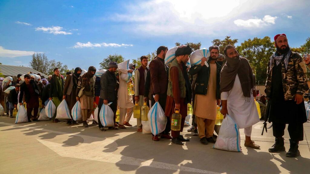 Internally displaced persons receive food aid distributed by the Turkish embassy in Kabul, Afghanistan, on October 30th. Photograph: EPA