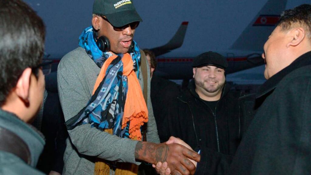 Retired US basketball star Dennis Rodman shakes hands with officials upon arrival at Pyongyang airport, North Korea. Photograph: Kyodo/Reuters