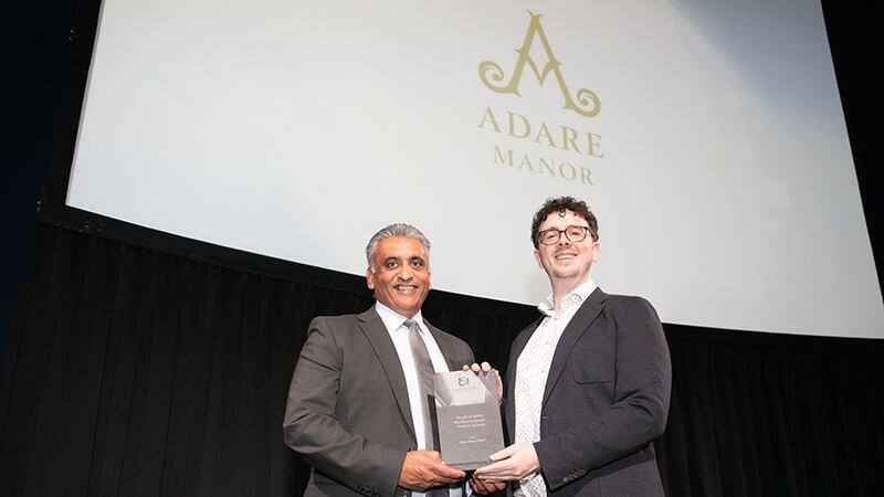 Sanjay Patel, Key Account Director at ISS Facility Services, presents the Health & Safety Excellence Award - Hotel & Leisure award to Darragh Feiritéar, Head of Judging, on behalf of Adare Manor Resort.