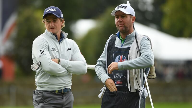 Dunne with caddie Darren Reynolds on the fifth green. Photo: Ross Kinnaird/Getty Images