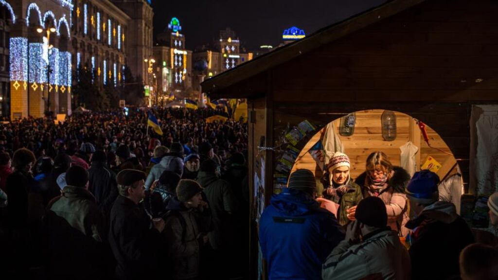 Anti-government protesters are served tea from a small booth in Independence Square. Photograph: Brendan Hoffman/Getty Images