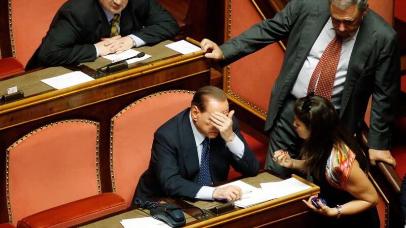 Silvio Berlusconi, Italy’s former prime minister, center, reacts as colleagues speak to him during a parliamentary session inside the Senate, the upper house of parliament, in Rome, Italy, todayt. Photographer: Alessia Pierdomenico/Bloomberg
