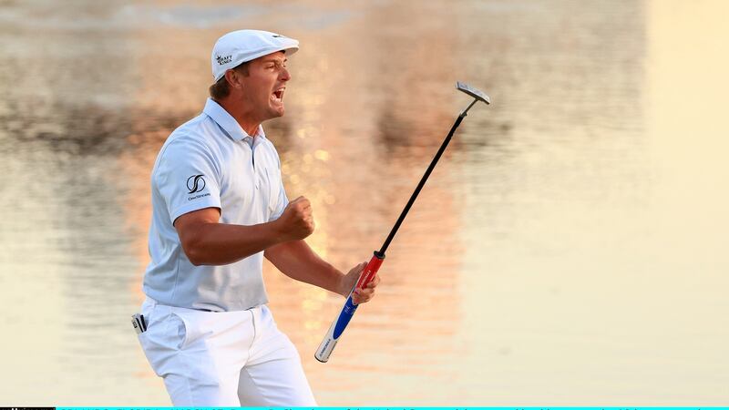 DeChambeau celebrates making his putt on the 18th green to win. Photo: Mike Ehrmann/Getty Images