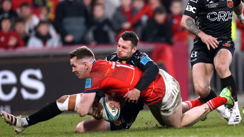 Munster’s Chris Farrell scores a try despite the efforts of Dragons’ Josh Lewis during the the United Rugby Championship match at Thomond Park. Photograph: James Crombie/Inpho