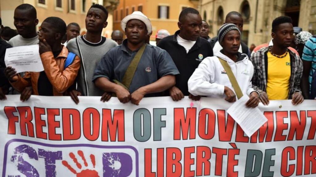 Asylum seekers hold a banner asking for freedom of movement and work in Europe, during a demonstration in front of the Italian parliament in Rome yesterday. Photograph: Gabriel Bouys/AFP/Getty Images