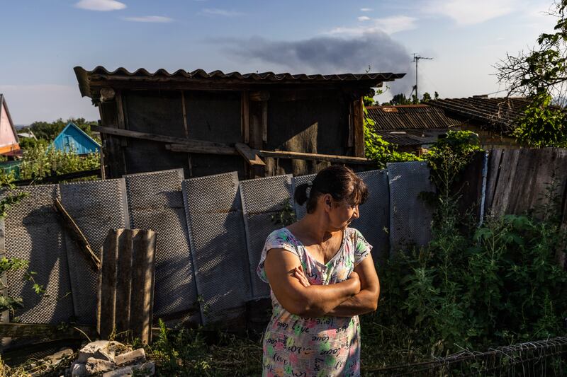 A resident of Nikopol, Ukraine, in the backyard of her home, where she said an unexploded Russian military shell landed. Photograph: David Guttenfelder/The New York Times