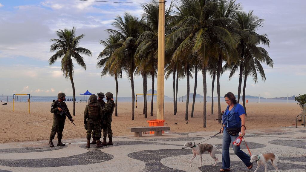Brazilian soldiers patrol at Copacabana beach. Photograph:  Carl De Souza /AFP/Getty Images