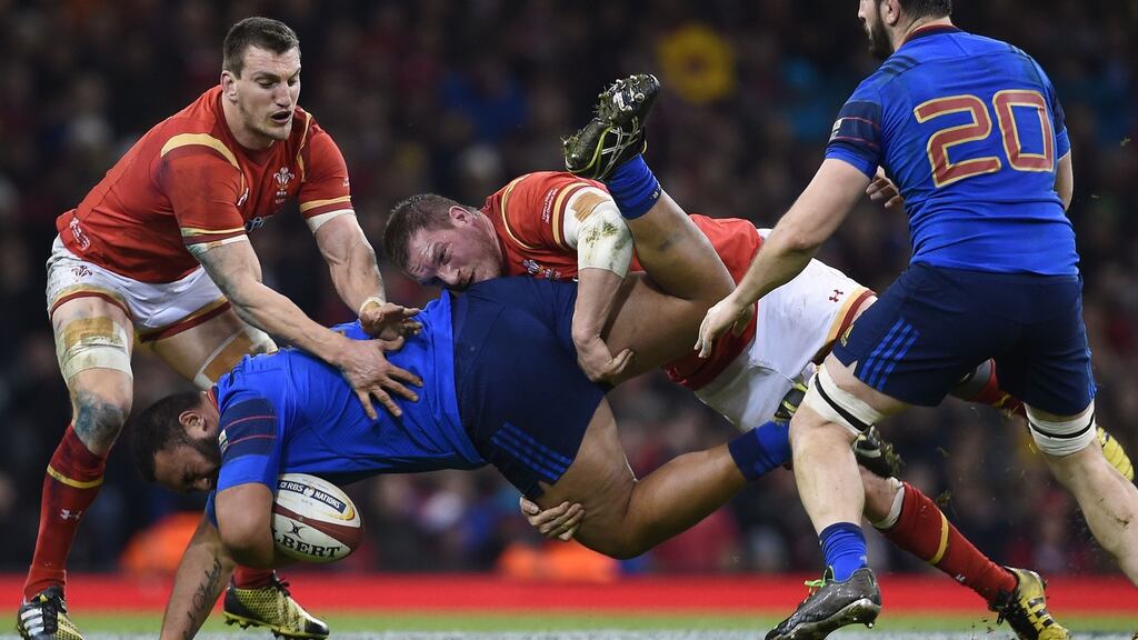 Wales’ Sam Warburton and Gethin Jenkins combine to tackle France’s Vincent Pelo during the 2016 RBS Six Nations match at the Principality Stadium, Cardiff. Photo: Joe Giddens/PA