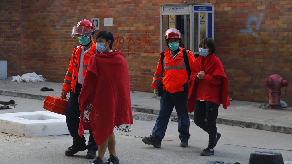 Protesters and medical staff leave the Hong Kong Polytechnic University in Hong Kong on Thursday. Photograph: Fazry Ismail/EPA