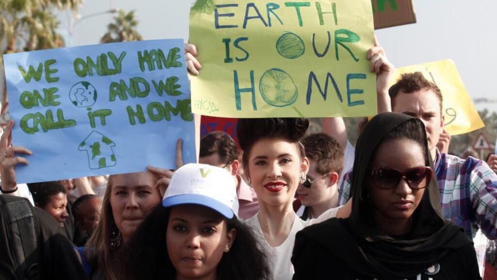 Activists marching last year in Doha to demand action to address climate change – “Earlier this year, atmospheric carbon dioxide levels breached 400ppm, their highest levels in at least three million years.” Photograph: Mohammed Dabbous/Reuters