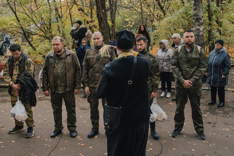A priest blesses conscripts outside a recruiting centre in Moscowin 2022. Photograph: Nanna Heitmann/New York Times
