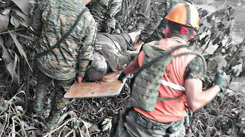 A handout picture released by the Guatemalan National Army shows army personnel rescue a victim of the volcano. Photograph: Getty