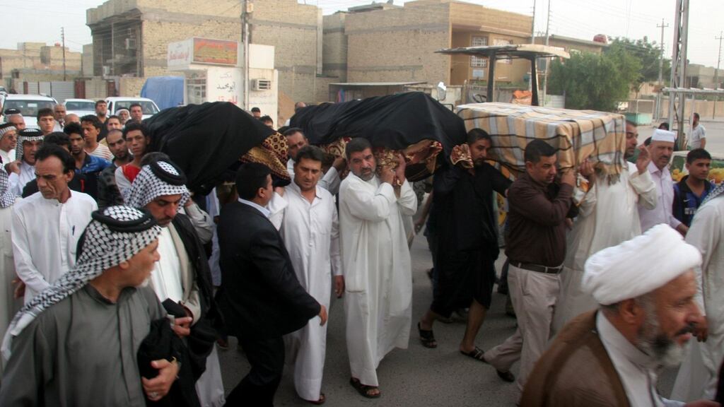 Iraqis carry the coffin of three victims killed in a car bomb attack in Shuala district northern Baghdad, Iraq today. Local media reports said at least 23 people were killed and 73 others were wounded in two car bomb attacks in Shuala and Kadhimiya district. Photograph: Ahmed Ali/EPA