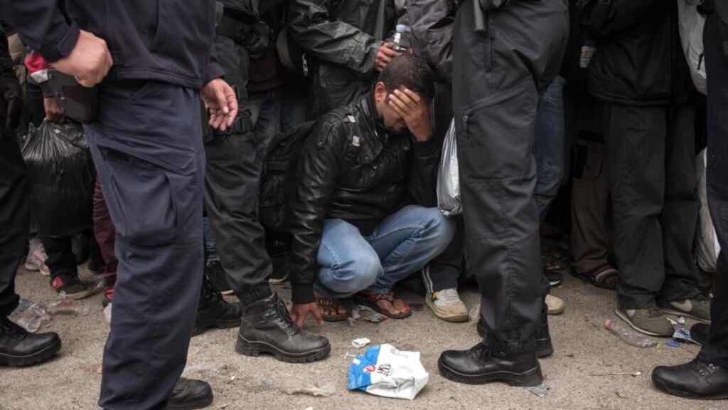 A migrant, surrounded by Croatian police, near the Opatovac transit centre for migrants and refugees, September 22nd, 2015. Photograph: Federico Scoppa/AFP/Getty Images