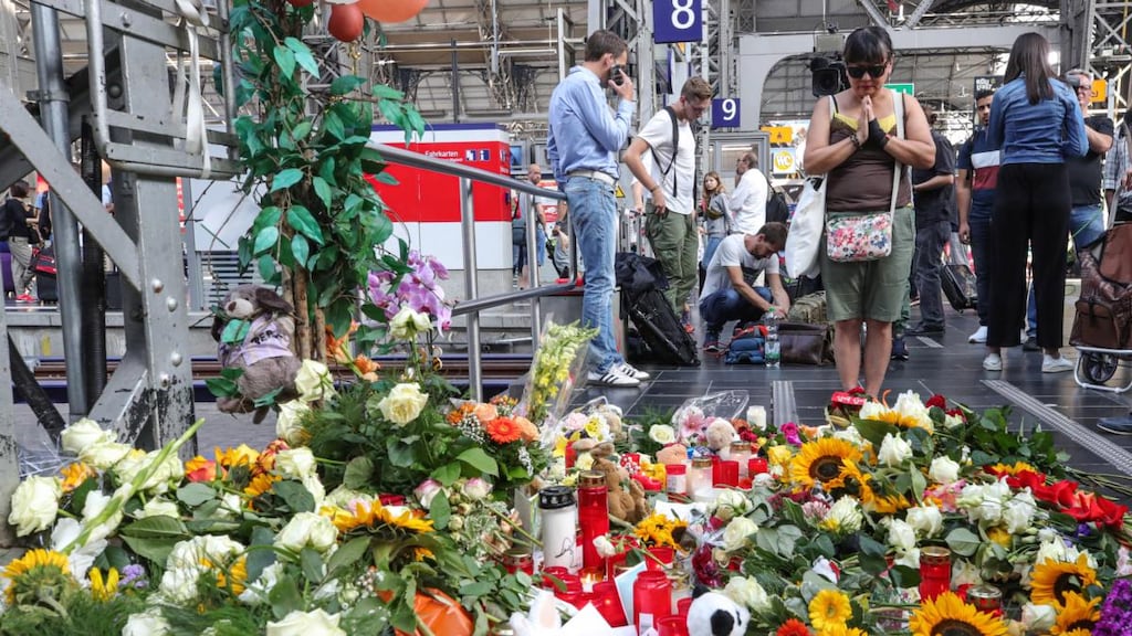 A woman pays tribute at the train station in Frankfurt where an eight-year-old boy died after being pushed in front of a train on Monday. Photograph: Armando BabanI/EPA
