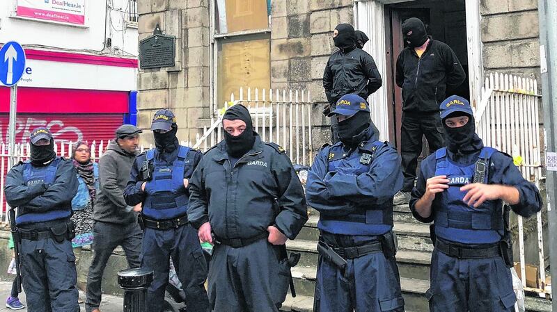 Gardaí from public order unit stand outside property in Dublin city. Photograph: Jack Power