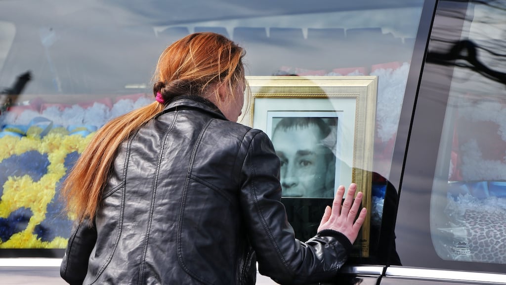 Angelina Power, Martin O’Rourke’s fiancée, looks at a picture of him in the hearse after his funeral. Photograph: Colin Keegan, Collins Dublin