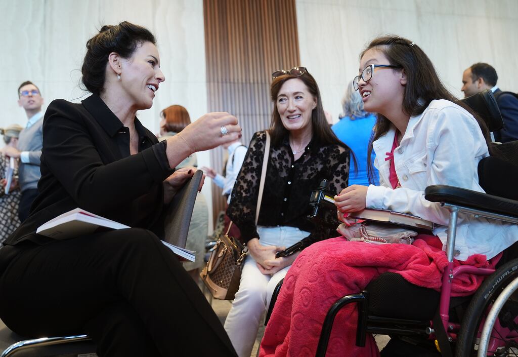 Minister for Health Jennifer Carroll MacNeill (left) in conversation with Emily Naik (right) and her mother Lillian Duffy, during the launch of the national rare disease strategy 2025-2030 at the Department of Health in Dublin. Photograph: Brian Lawless/PA Wire