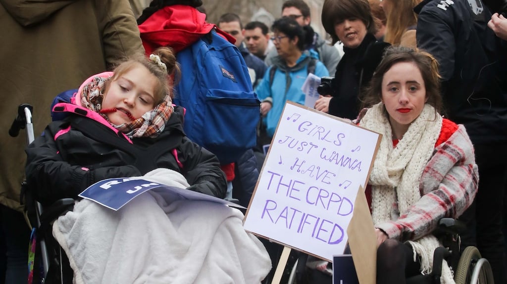 Bronwen O’ Reilly, Glasnevin and Trinity student Niamh Herbert, Kildare during a Dáil protest demanding ratification of the UN Convention of the Rights of Persons with Disabilities. Photograph: Gareth Chaney Collins