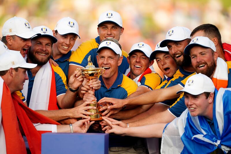 Team Europe Captain Luke Donald, alongside Rory McIlroy, lifts the Ryder Cup Trophy after Europe's victory over the USA at the Marco Simone Golf and Country Club, Rome,. Photograph: Mike Egerton/Inpho