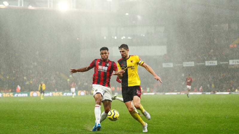 Bournemouth’s Joshua King tackles Watford’s Craig Cathcart. Photo: Andrew Boyers/Reuters