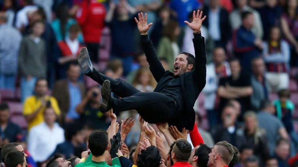 Atletico Madrid’s coach Diego Simeone celebrates with players after winning the Spanish first division title following their match against Barcelona at Camp Nou stadium in Barcelona. Photograph: Marcelo del Pozo/Reuters