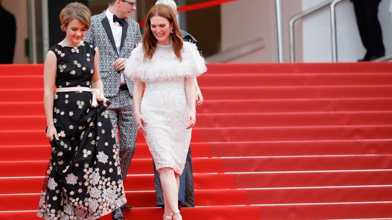 Millicent Simmonds and  Julianne Moore walk in front of screenwriter Brian Selznic as they leave the “Wonderstruck” screening  on May 18th, 2017 in Cannes, France. Photograph:  Andreas Rentz/Getty Images