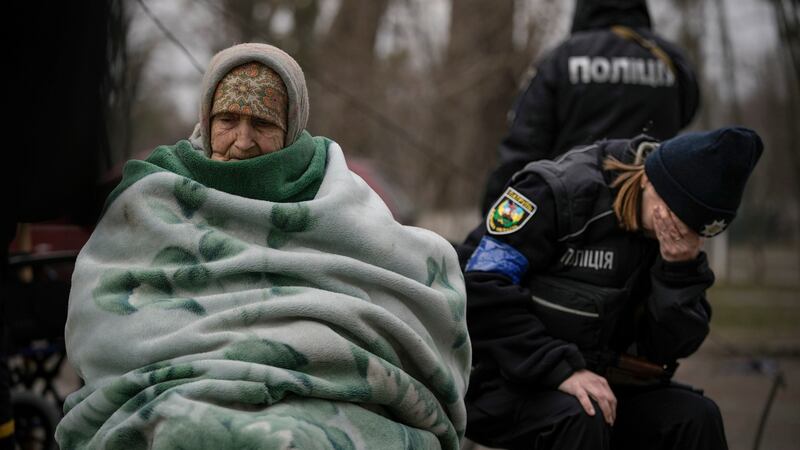 A Ukrainian police officer is overwhelmed by emotion after comforting people evacuated from Irpin on the outskirts of Kyiv. Photograph: Vadim Ghirda/AP