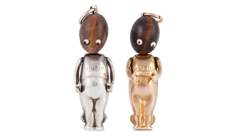 Two Fumsup Talismans, one in 9ct gold, one in silver, with wooden head and glass eyes, used as good-luck charms by soldiers in the wars, €80-€120, O’Reillys