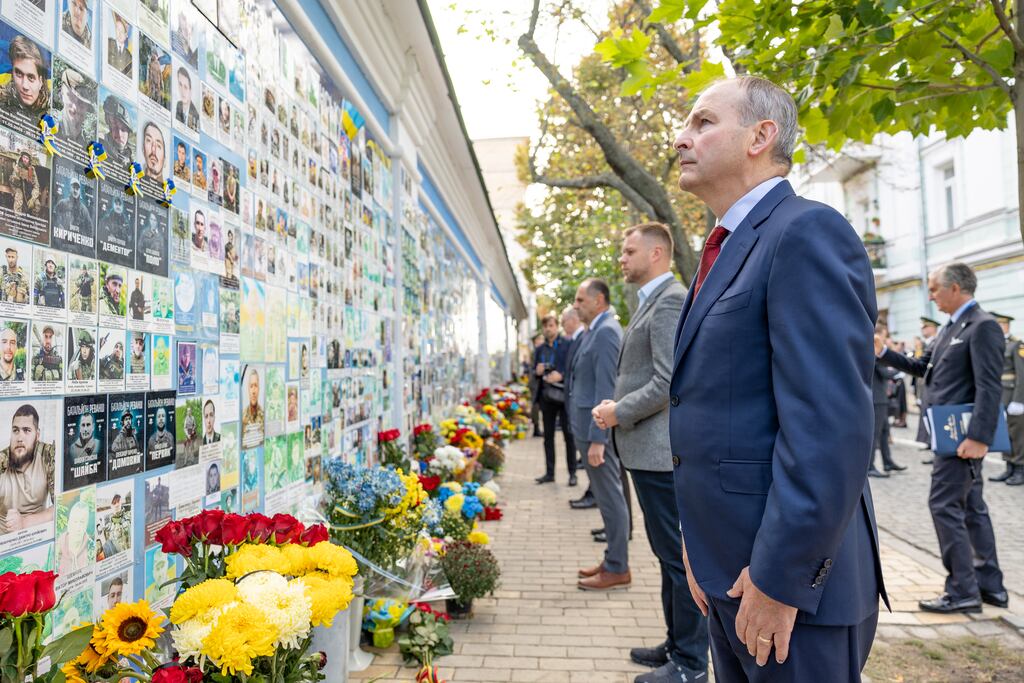 Tánaiste Micheál Martin lays flowers at the Memory Wall of Fallen Defenders of Ukraine in Kyiv: Mr Martin said he was taking the opportunity to meet United Nations agencies and EU civil missions, noting several Irish citizens worked for them. Photograph Irish Embassy in Kyiv