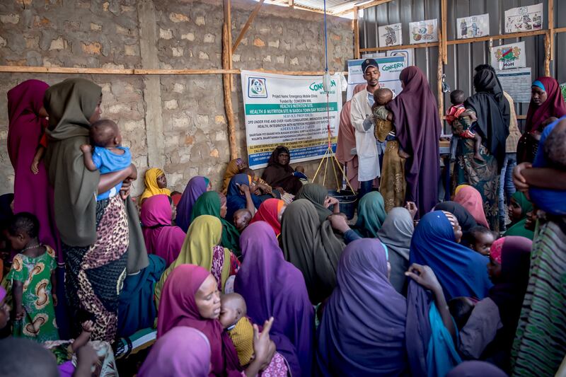 Women wait to have their children screened for malnutrition at a health clinic in Baidoa, Somalia. Photograph: Sally Hayden