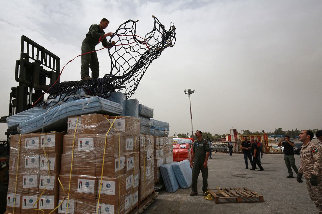 Soldiers at Marka military airport in Amman prepare to load a Jordanian plane with humanitarian aid for Libya, . Photograph: Khalil Mazraawi/AFP via Getty Images