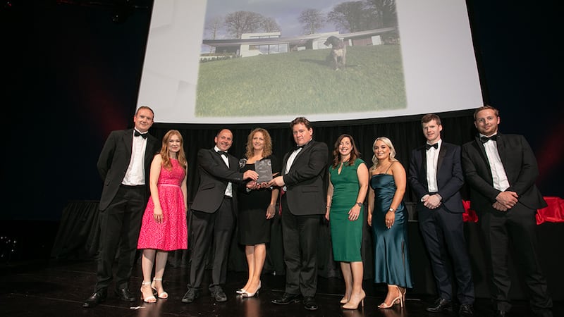 Justin Kinsella, Awards Judge, presents the Single House Building of the Year award to the Niall Smith Architects team.