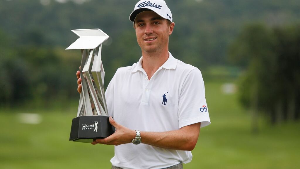 Justin Thomas of the United States poses with his trophy after winning the CIMB Classic golf tournament at Kuala Lumpur Golf and Country Club. Photograph: Joshua Paul/AP