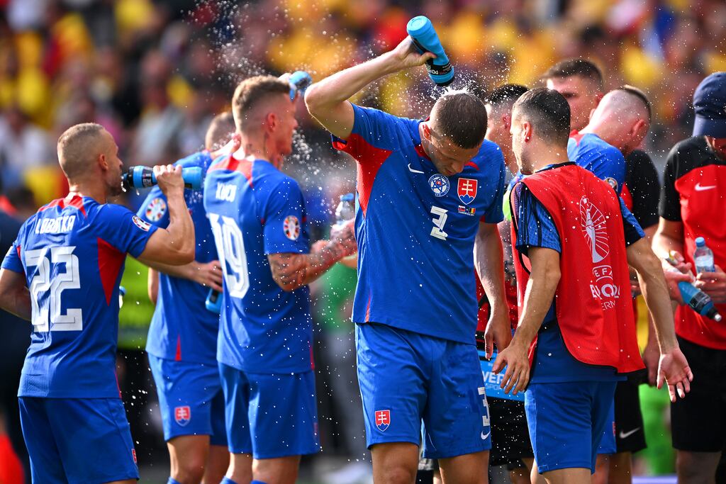 Slovakia's Denis Vavro sprays water on himself at a drinks break during the Euro 2024 group stage match against Romania at Frankfurt Arena. Photograph: Stu Forster/Getty Images