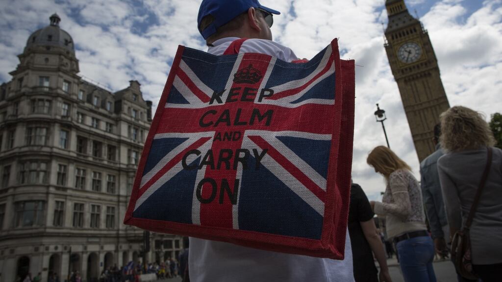 A tourist stands near the Houses of Parliament. Billions of pounds were wiped off the value of British financial stocks, and analysts at several banks slashed their forecasts for the pound in the wake of Britain’s vote on Thursday to leave the European Union. (Photograph: Joe Giddens/PA Wire)