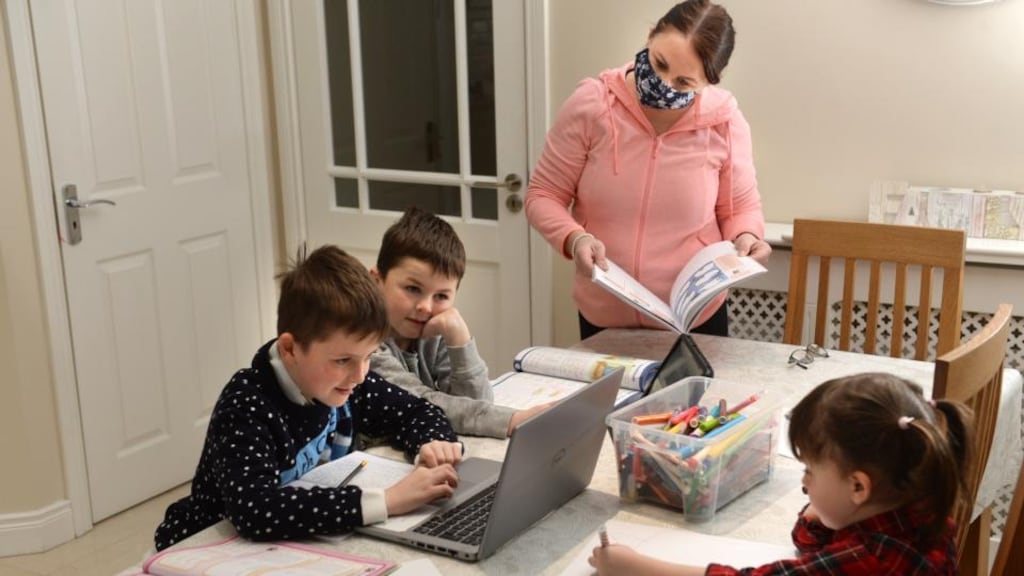Ryan and Shane Kenny with their mother, Claire, and sister Karina during some homeschooling in Kilcock, Co Kildare. Photograph: Dara Mac Dónaill