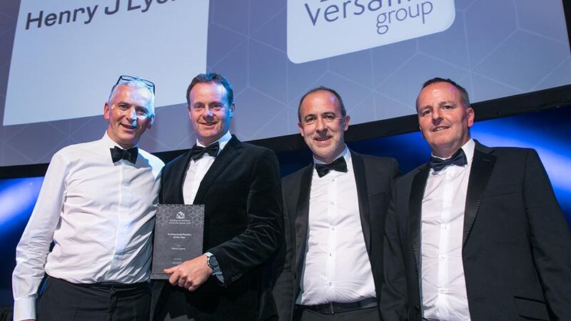 Andrew Treacy, Managing Director, Versatile Group presents the Architectural Practice of the Year award to the Henry J Lyons team.