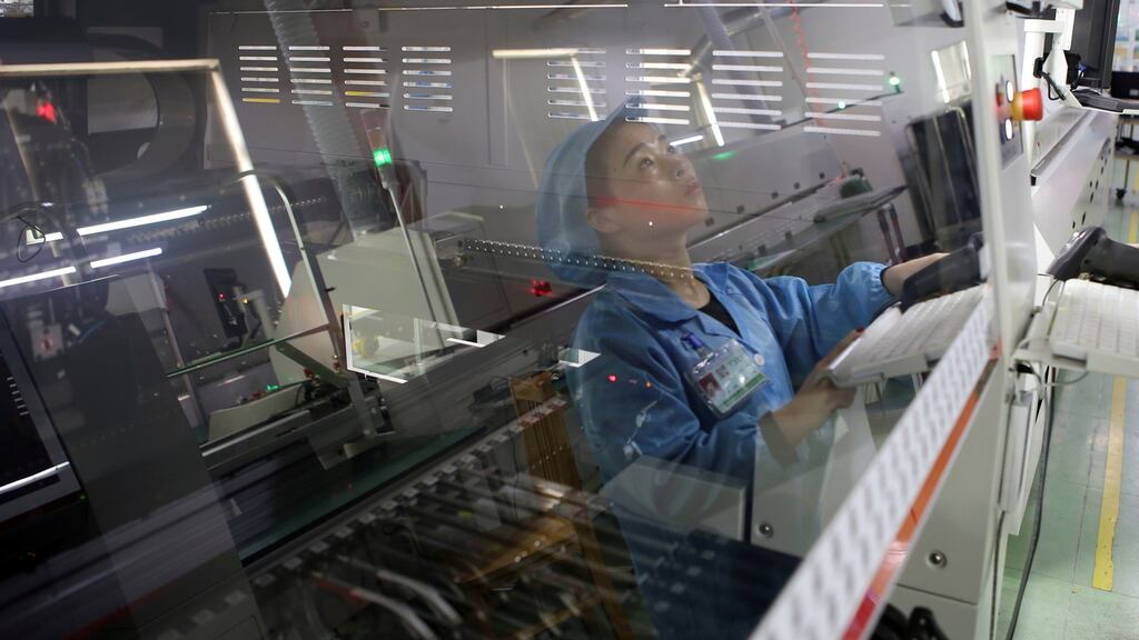 An employee working on the production line of an electronics factory in Jiaxing, Zhejiang province. Photograph: Reuters