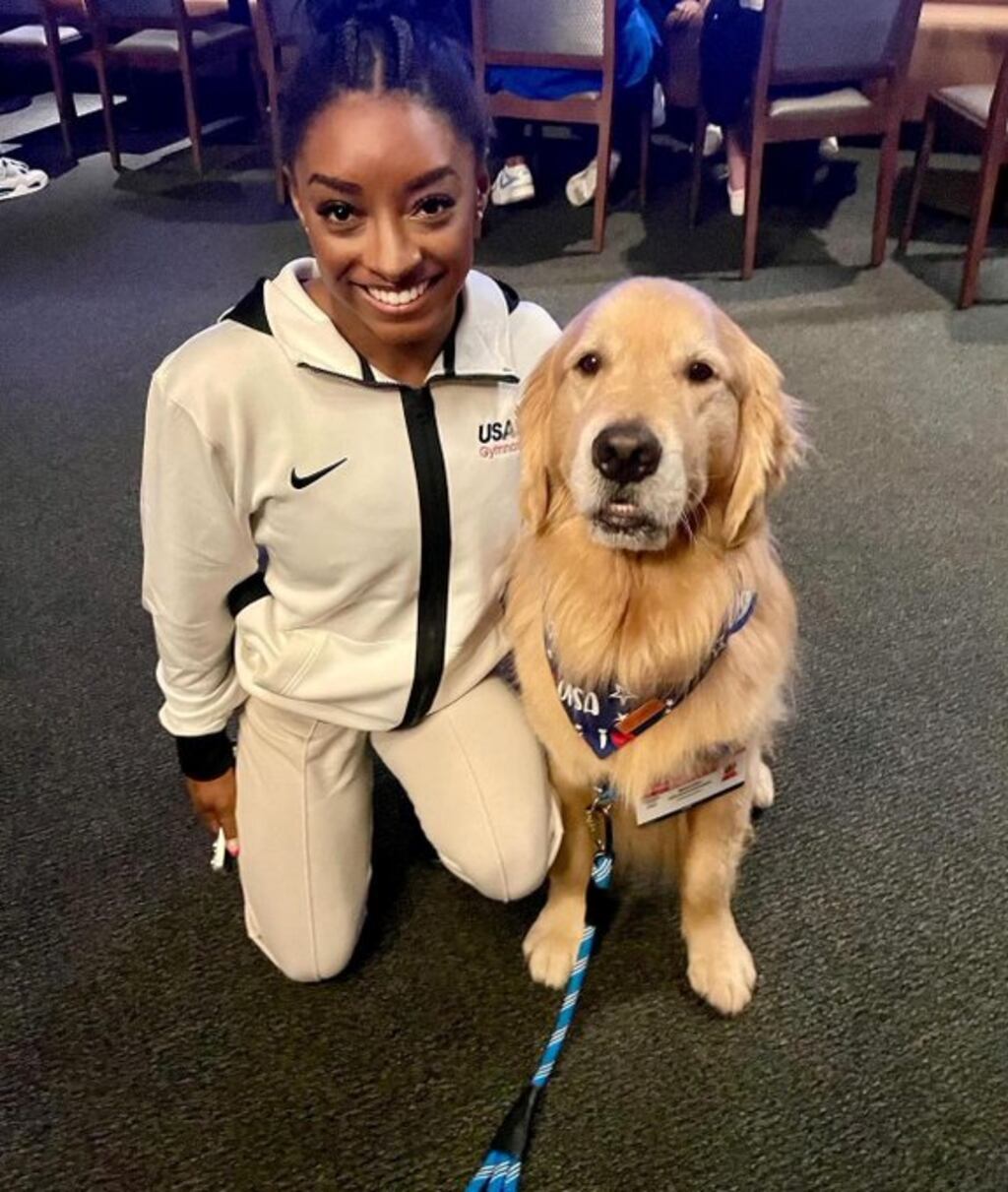 US gymnast Simone Biles with Beacon, an emotional support dog . Photograph: X