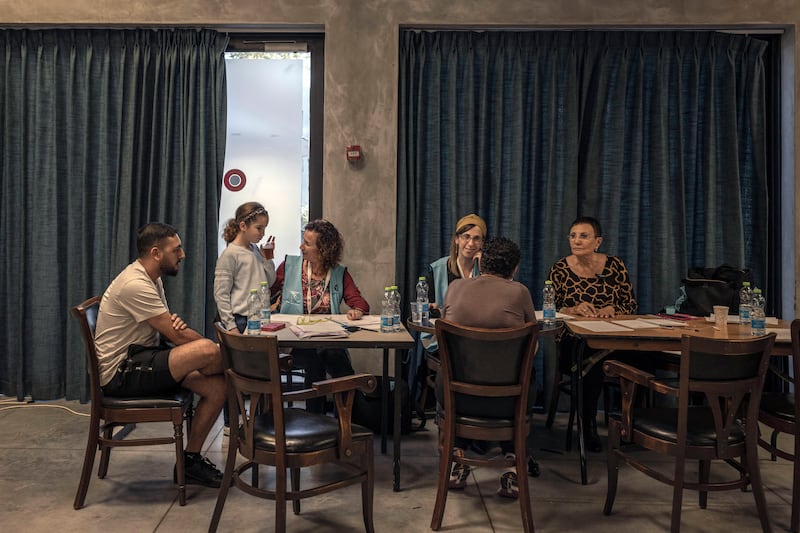 Residents of Kfar Aza learn more about the assistance they can receive as victims of the Hamas attack during a meeting in Shefayim, Israel, where they are temporarily living, earlier this month. Photograph: Avishag Shar-Yashuv/New York Times